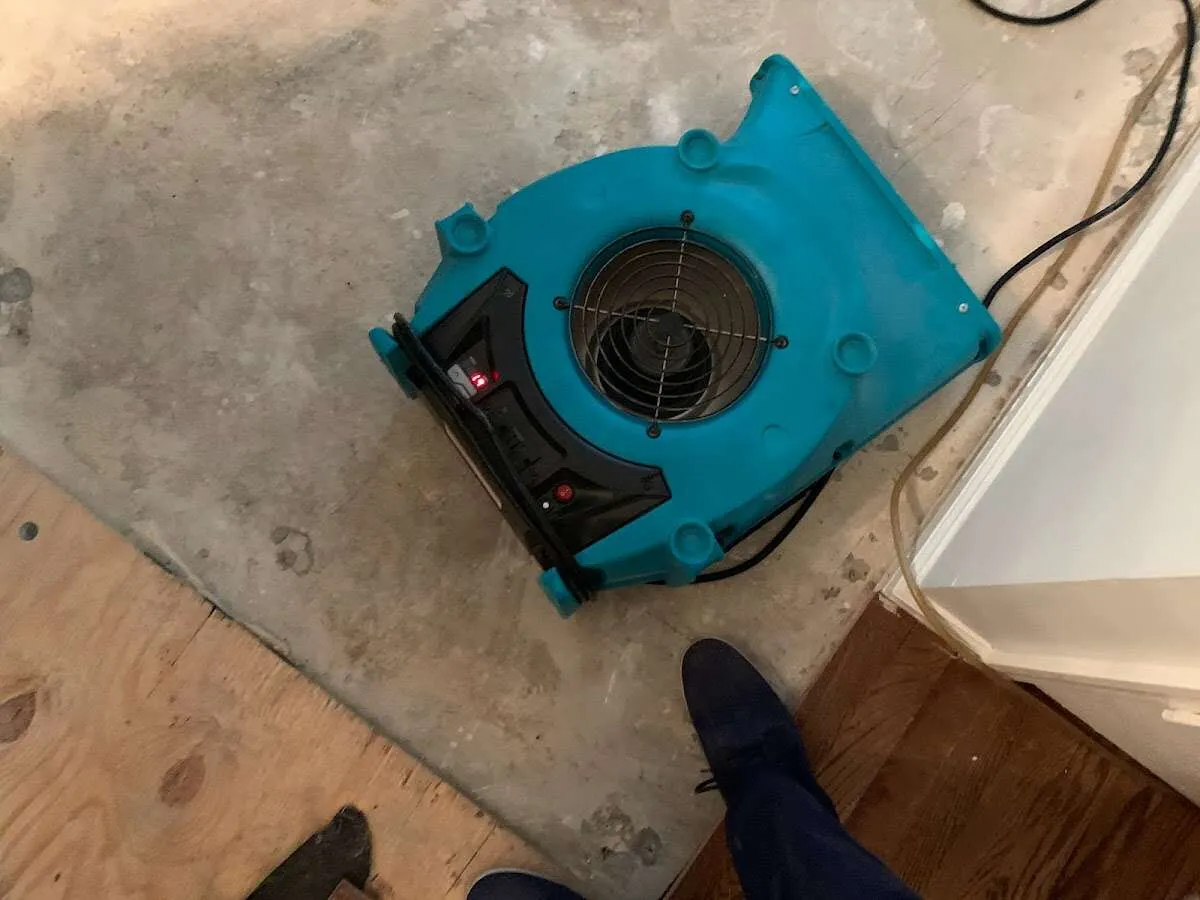 Air mover drying subfloor during Commercial Water Damage Restoration in North Manchester